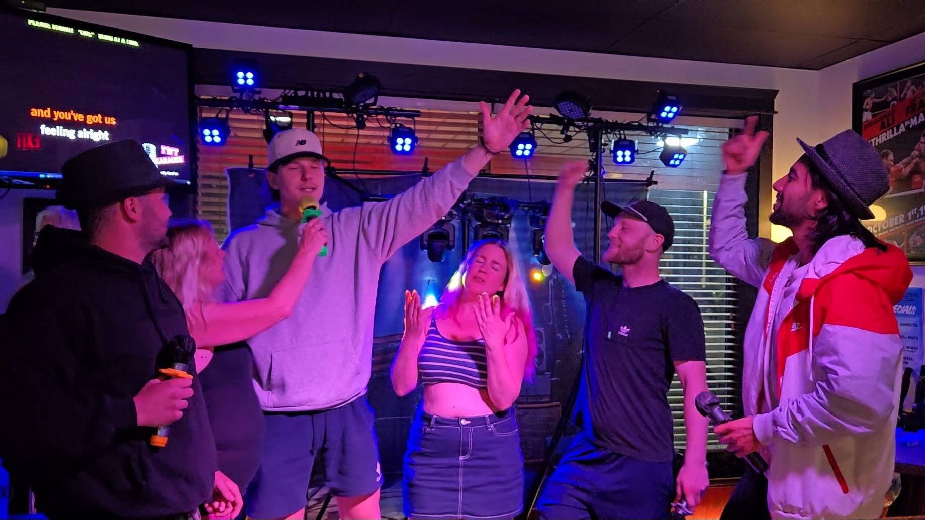 Crowd singing along at karaoke night