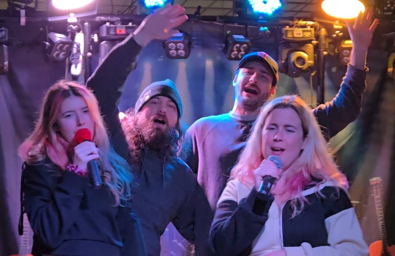 Friends singing karaoke at Pitcher's