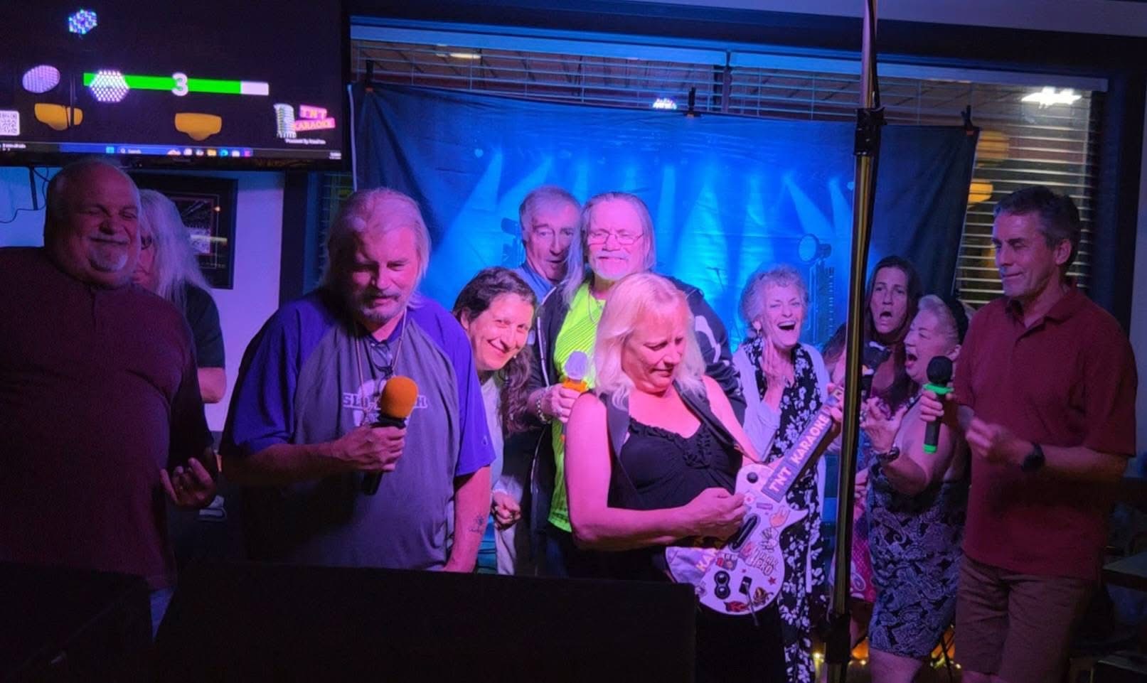 Group singing karaoke at Pitcher's